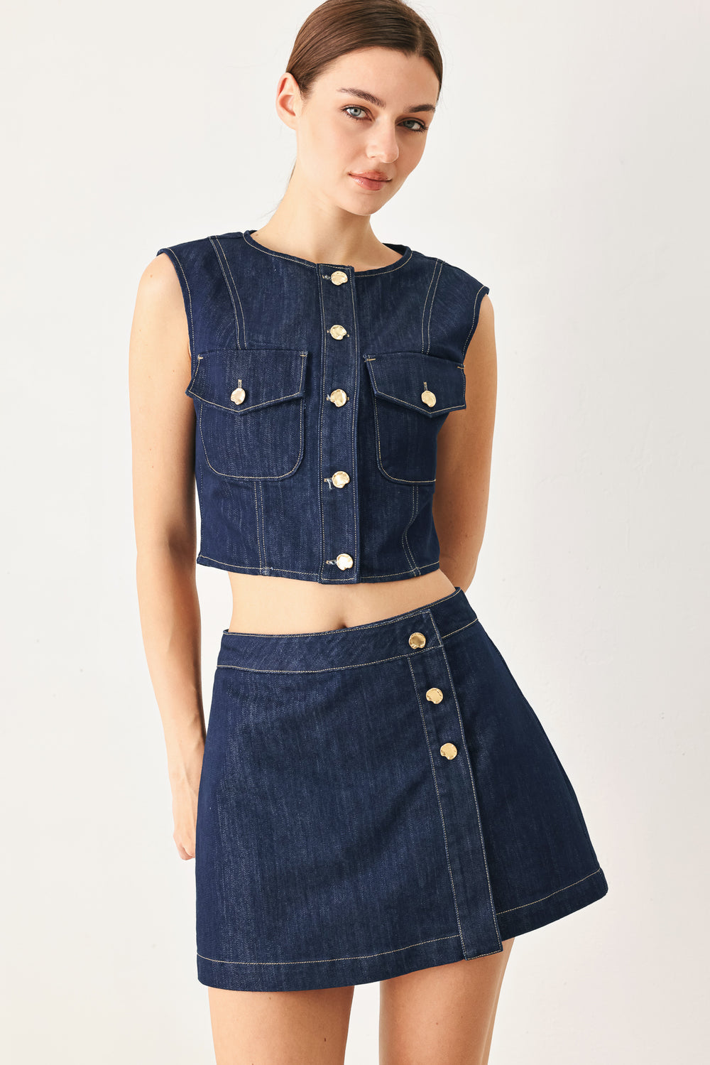 Woman wearing a denim denim crop vest with front button closure | FREEMARKET