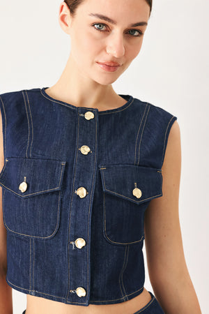 Woman wearing a denim denim crop vest with front button closure | FREEMARKET