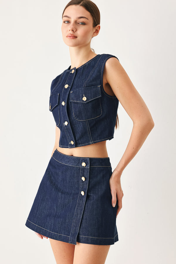 Woman wearing a denim denim crop vest with front button closure | FREEMARKET