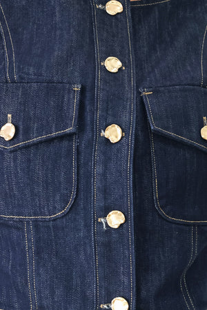Woman wearing a denim denim crop vest with front button closure | FREEMARKET