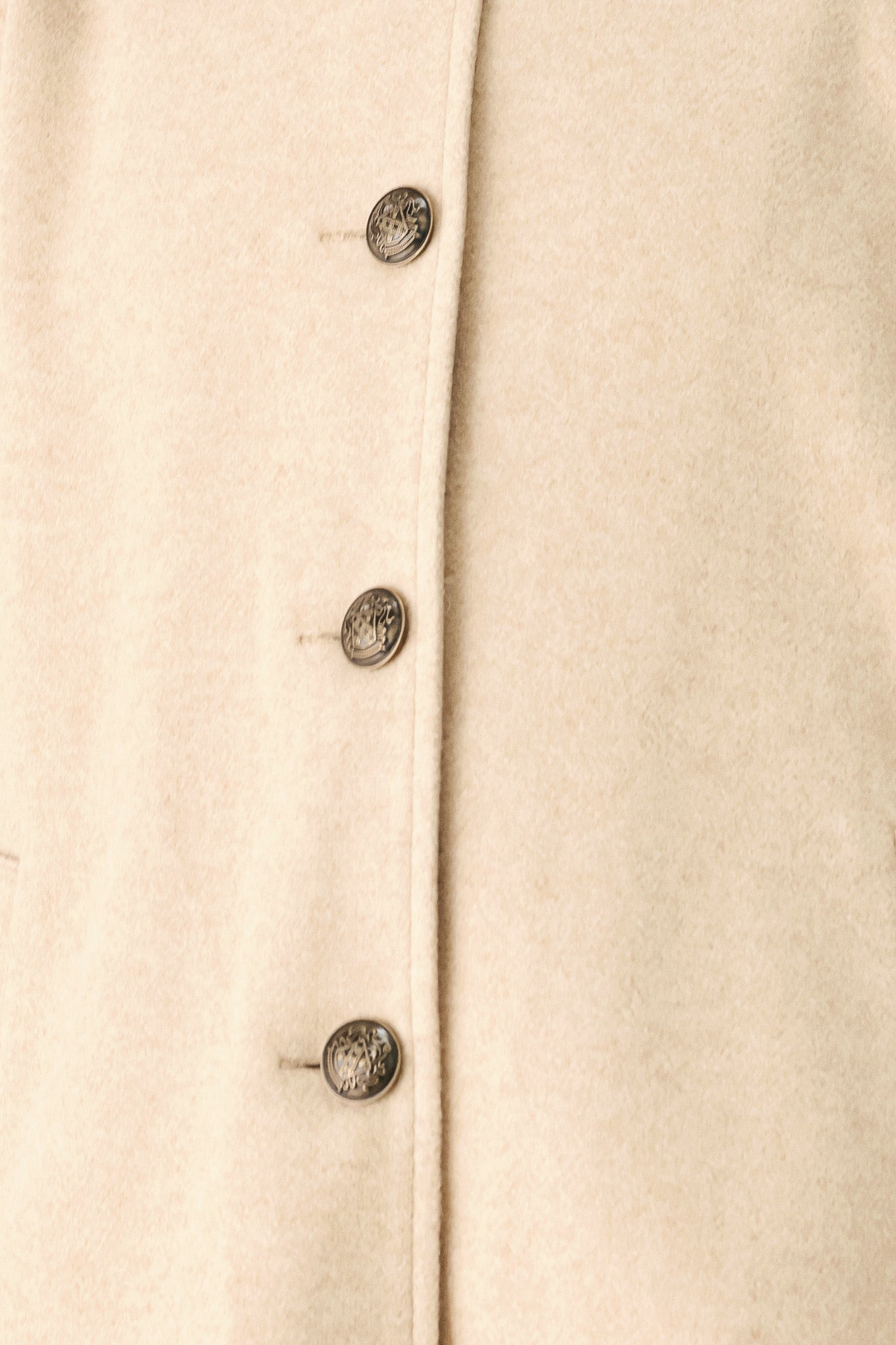 A model wearing a beige cropped cape jacket with a brown collar, buttoned front, and wide sleeves | FREEMARKET