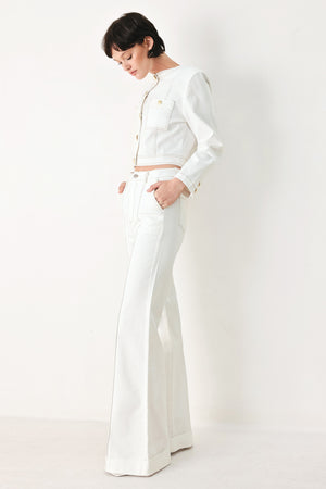 Woman wearing a white denim crop jacket featuring round neckline, long sleeve, pockets and front button down | FREEMARKET