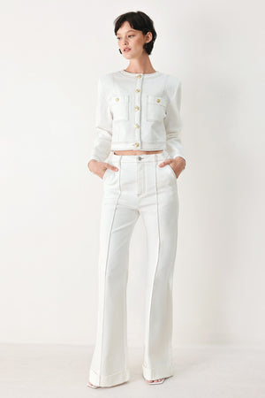 Woman wearing a white denim crop jacket featuring round neckline, long sleeve, pockets and front button down | FREEMARKET