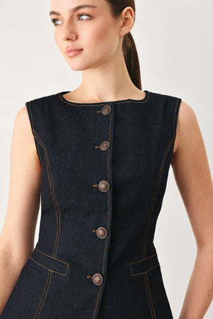 Woman wearing a dark denim vest with wide neckline and front button down | FREEMARKET