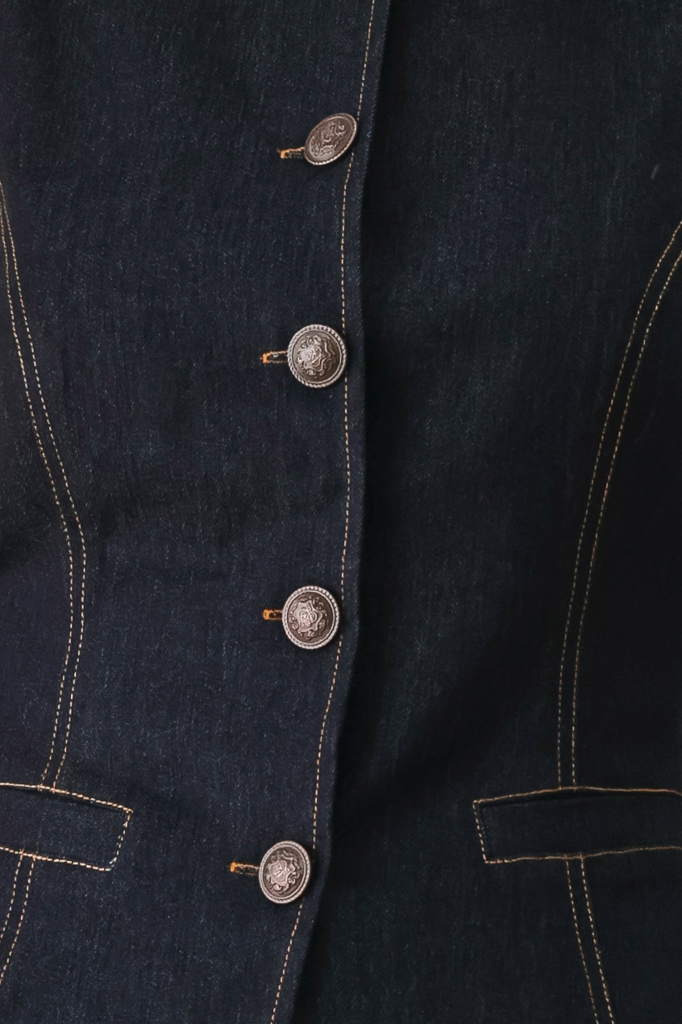 Woman wearing a dark denim vest with wide neckline and front button down | FREEMARKET