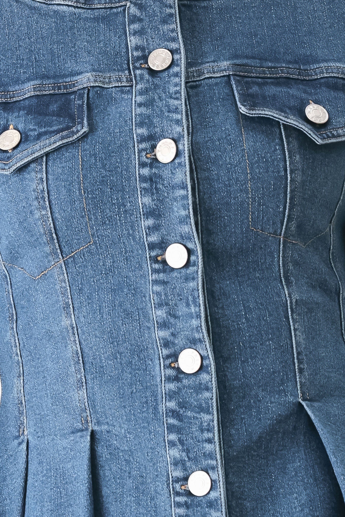 A woman wearing a cropped blue denim jacket with silver buttons and peplum waist | FREEMARKET