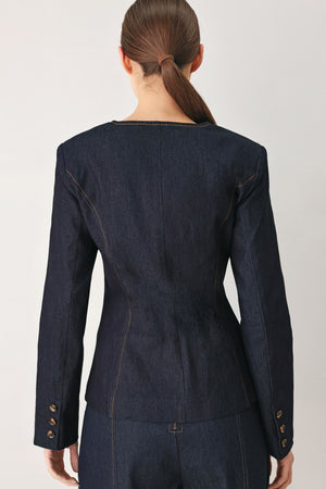Woman wearing a dark denim jacket with round neckline, long sleeve and front button closure | FREEMARKET
