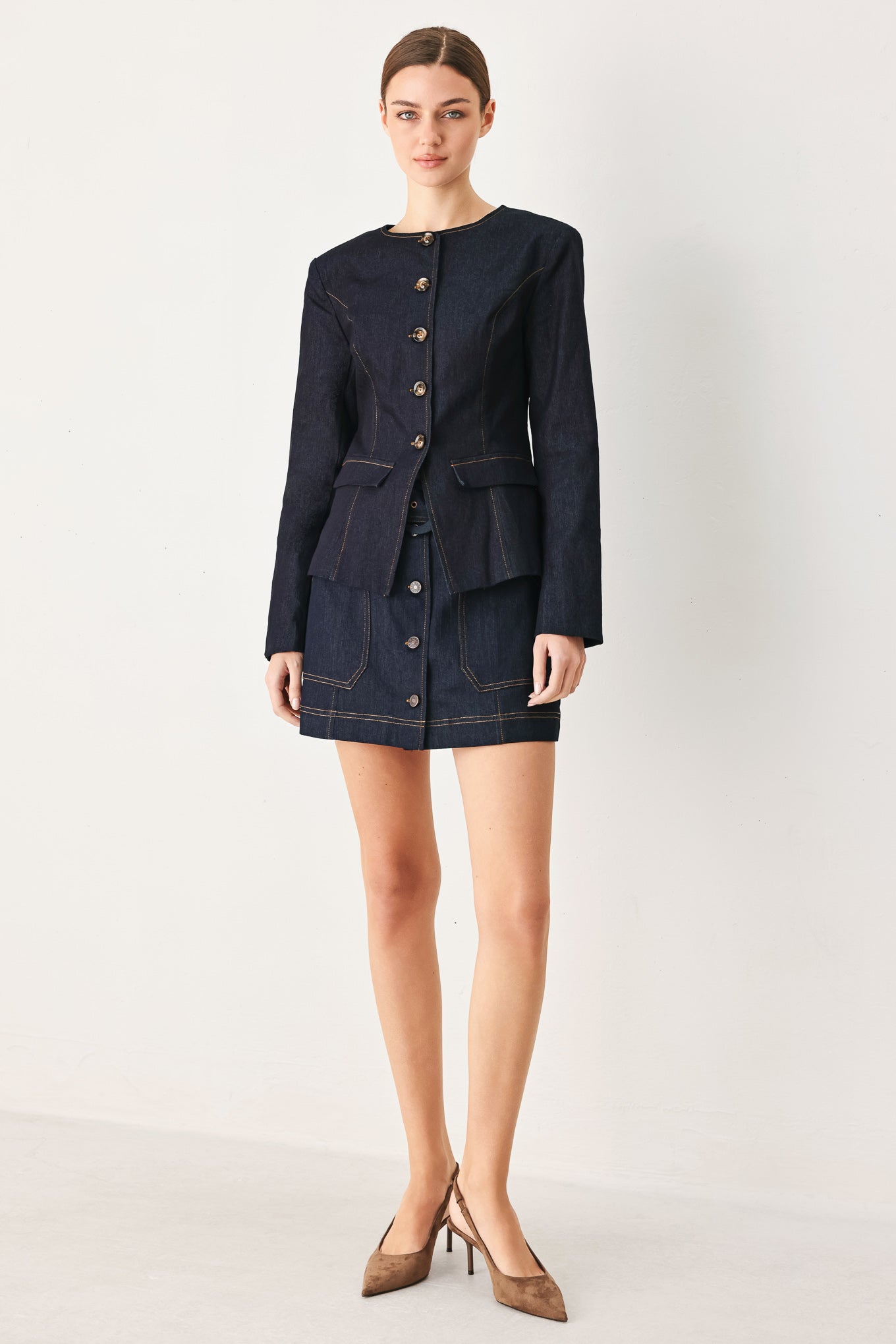 Woman wearing a dark denim jacket with round neckline, long sleeve and front button closure | FREEMARKET