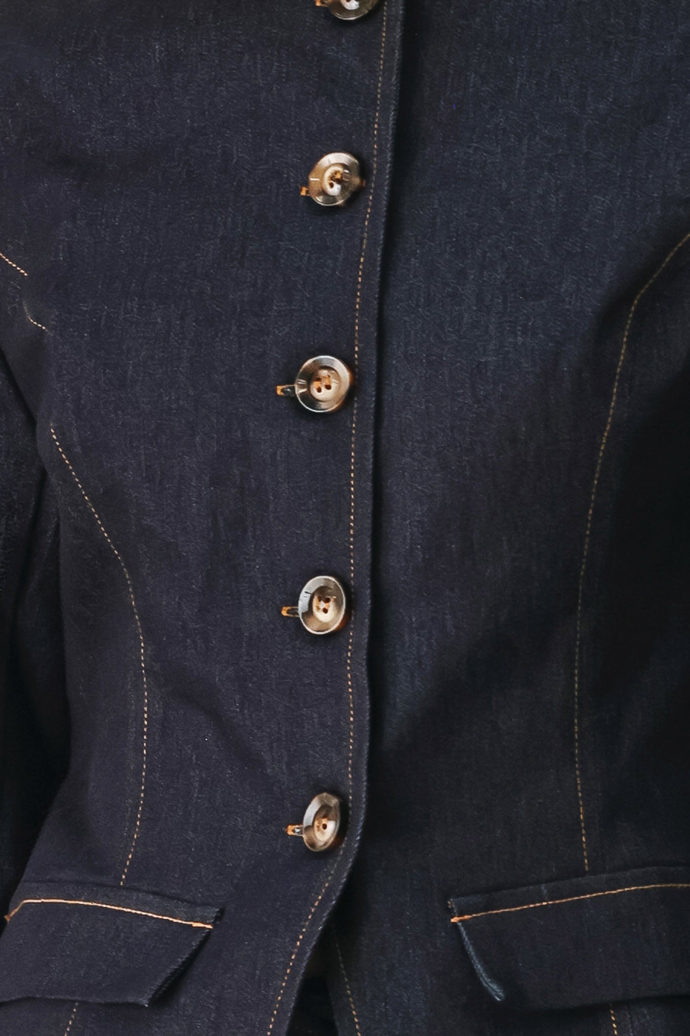 Woman wearing a dark denim jacket with round neckline, long sleeve and front button closure | FREEMARKET
