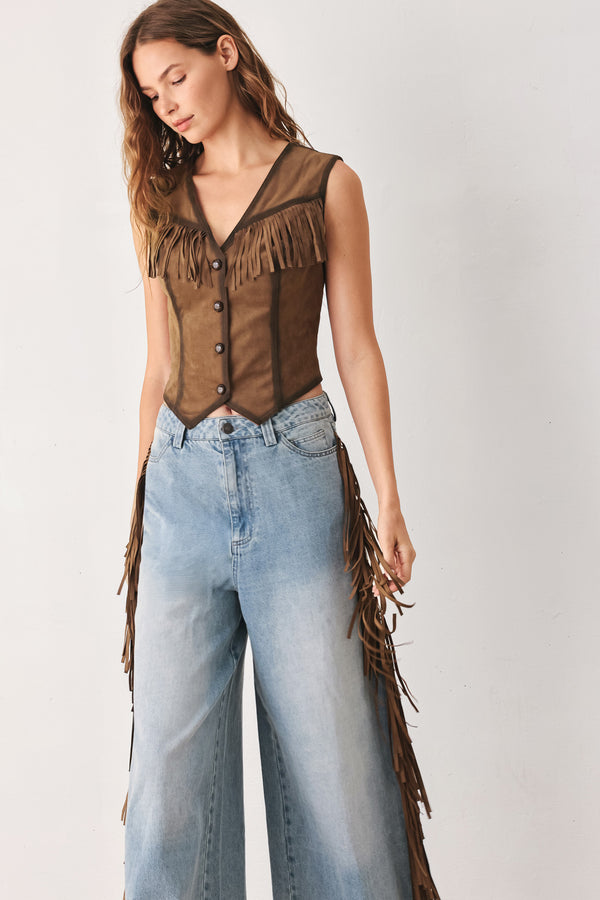 A woman modeling a brown faux-suede vest with fringe trim and button-front detailing | FREEMARKET