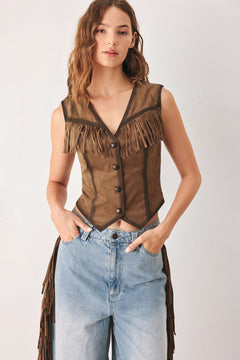 A woman modeling a brown faux-suede vest with fringe trim and button-front detailing | FREEMARKET