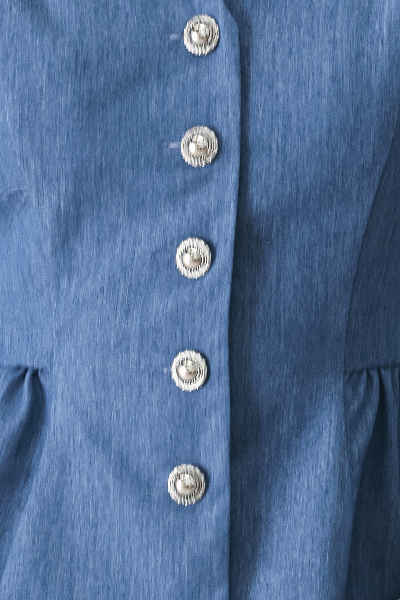 Close up of a woven blue vest with front closure, sleeveless and peplum | FREEMARKET