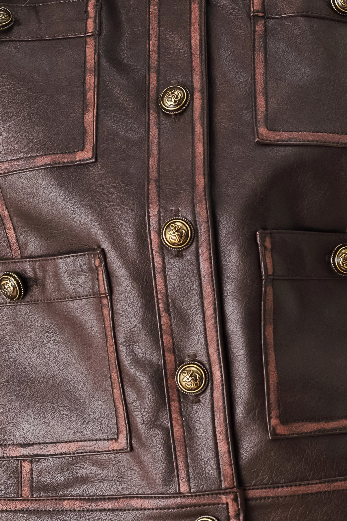 Woman wearing a brown long sleeve faux leather cropped jacket with button closure and small chest pockets with button adornments | FREEMARKET
