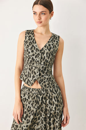 Woman wearing a brown and black leopard print vest with buttons | FREEMARKET
