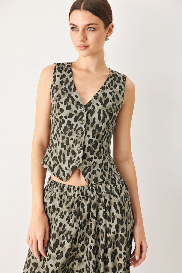 Woman wearing a brown and black leopard print vest with buttons | FREEMARKET