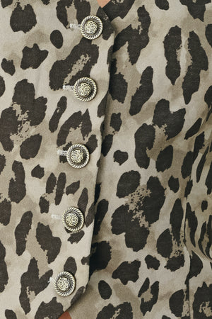 Woman wearing a brown and black leopard print vest with buttons | FREEMARKET