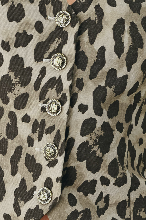 Woman wearing a brown and black leopard print vest with buttons | FREEMARKET