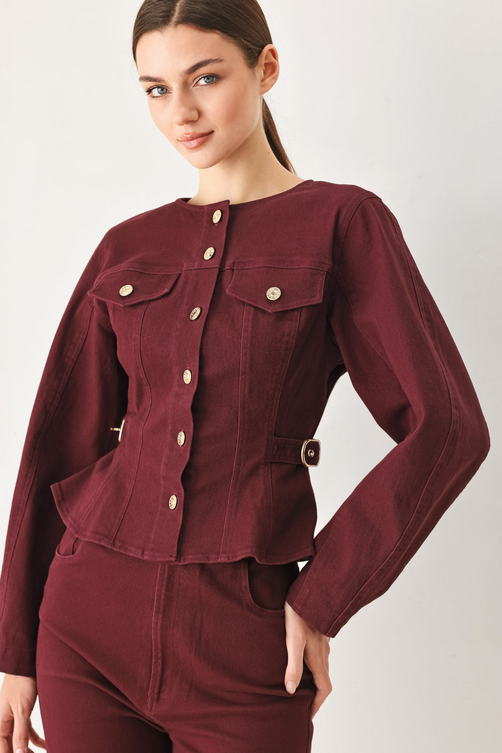 Woman wearing a long-sleeve jacket in deep burgundy with gold-tone buttons | FREEMARKET
