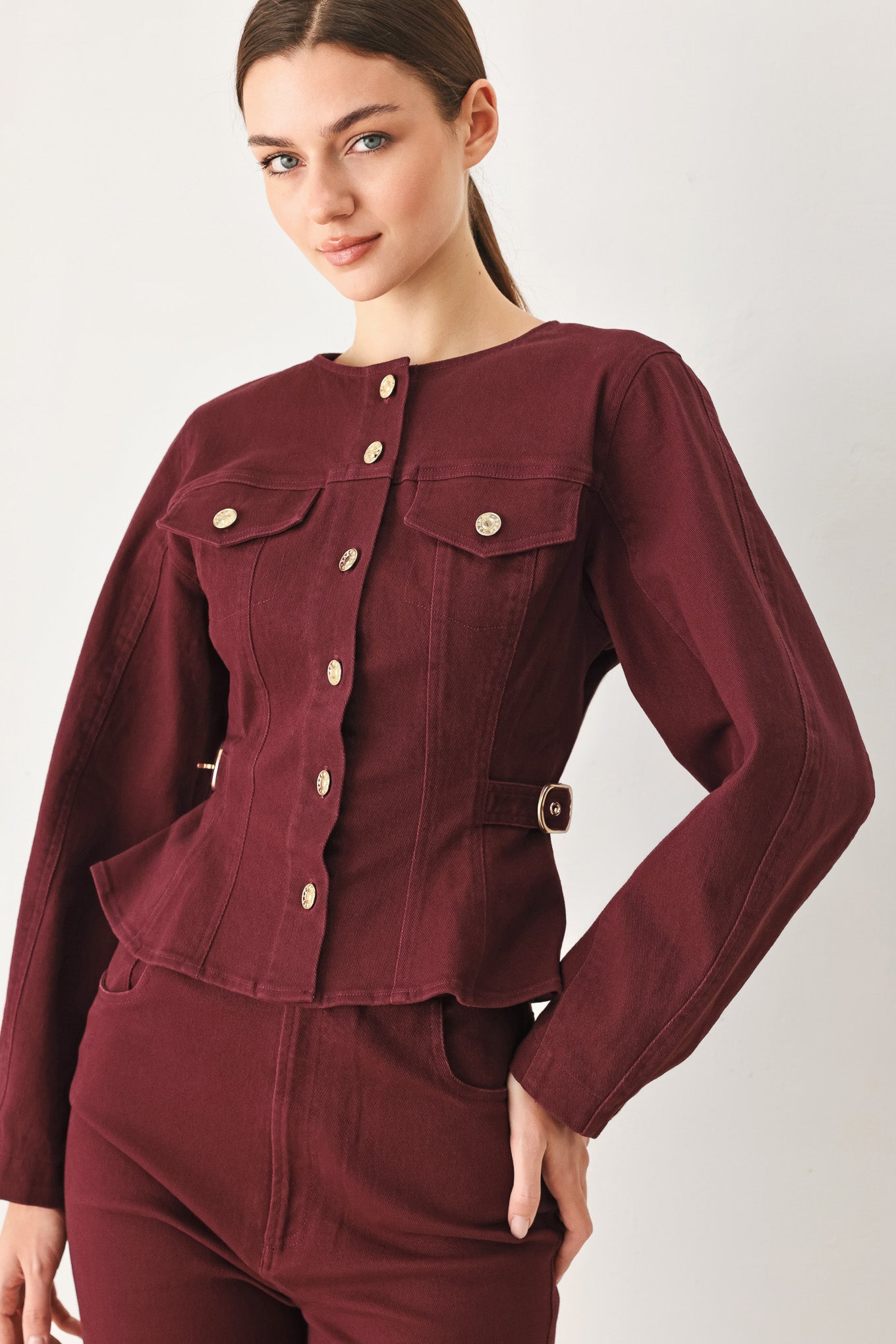 Woman wearing a long-sleeve jacket in deep burgundy with gold-tone buttons | FREEMARKET