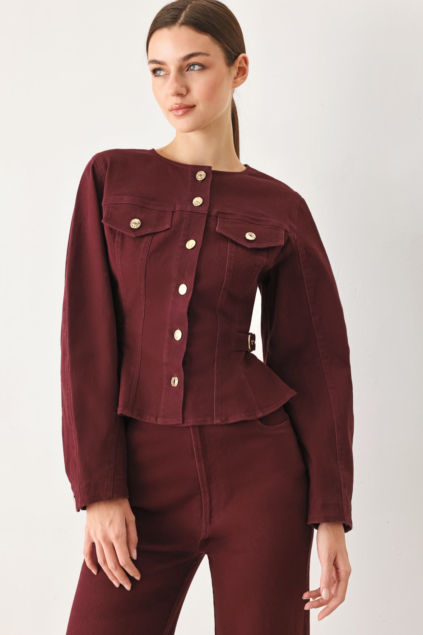 Woman wearing a long-sleeve jacket in deep burgundy with gold-tone buttons | FREEMARKET