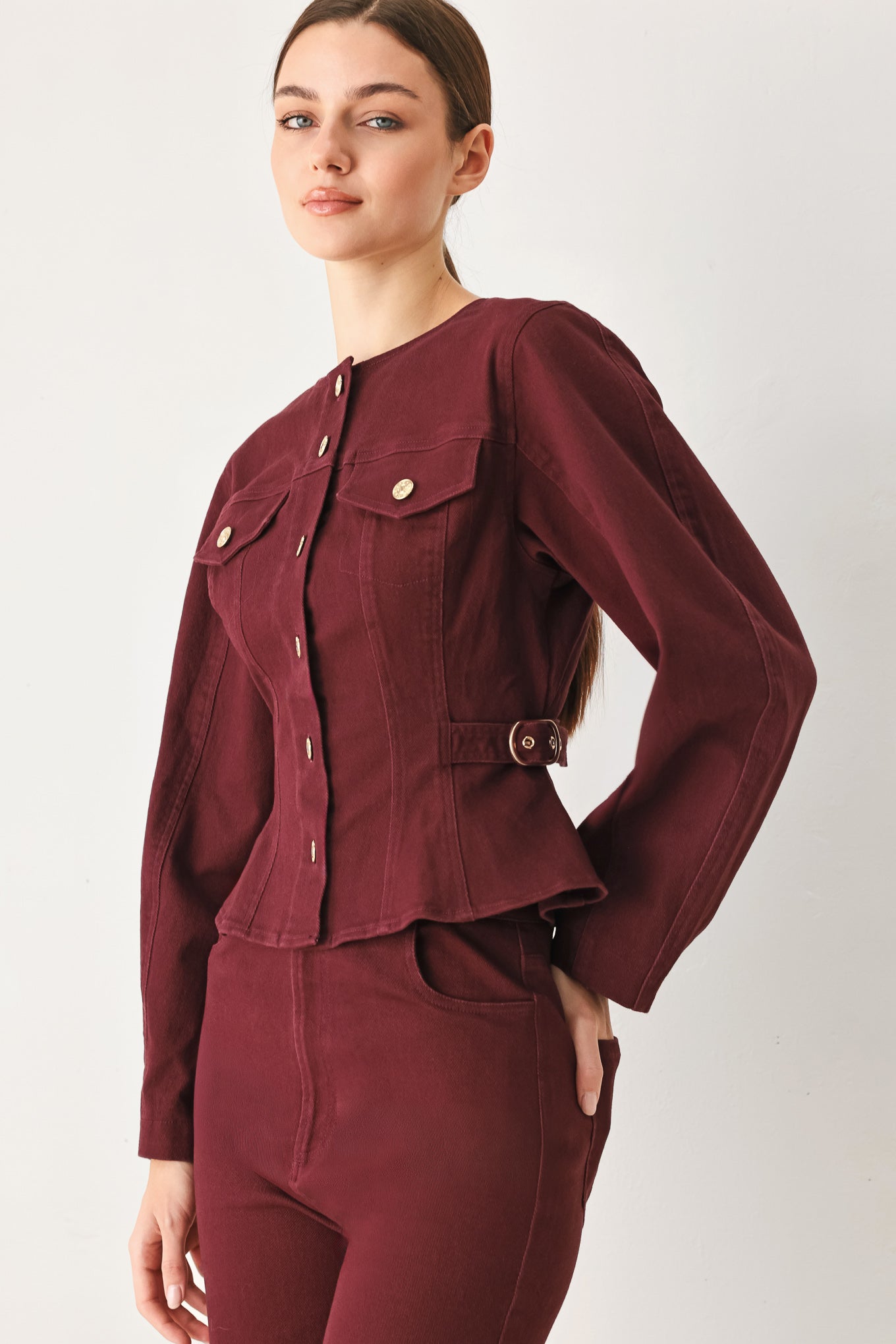 Woman wearing a long-sleeve jacket in deep burgundy with gold-tone buttons | FREEMARKET