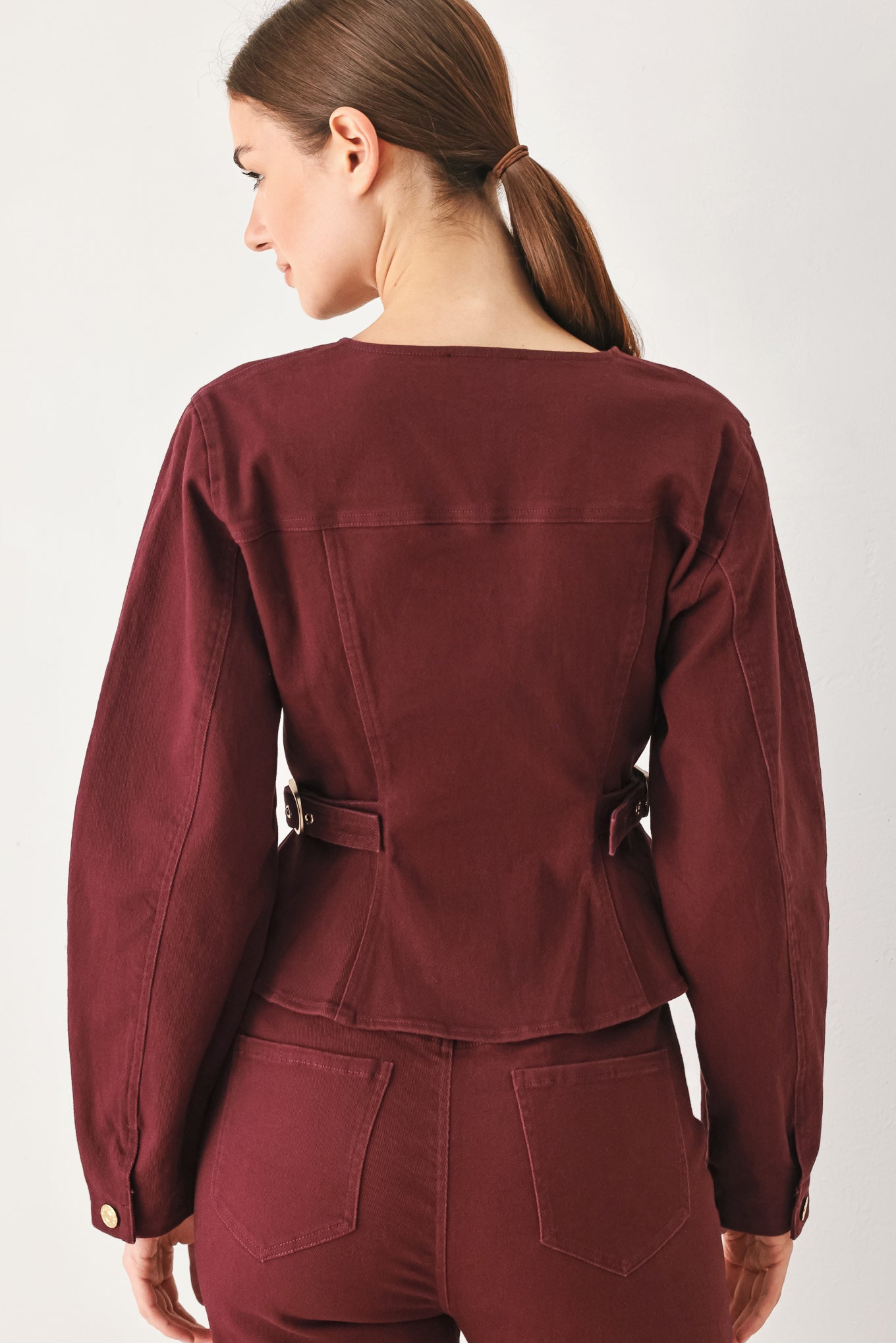 Woman wearing a long-sleeve jacket in deep burgundy with gold-tone buttons | FREEMARKET