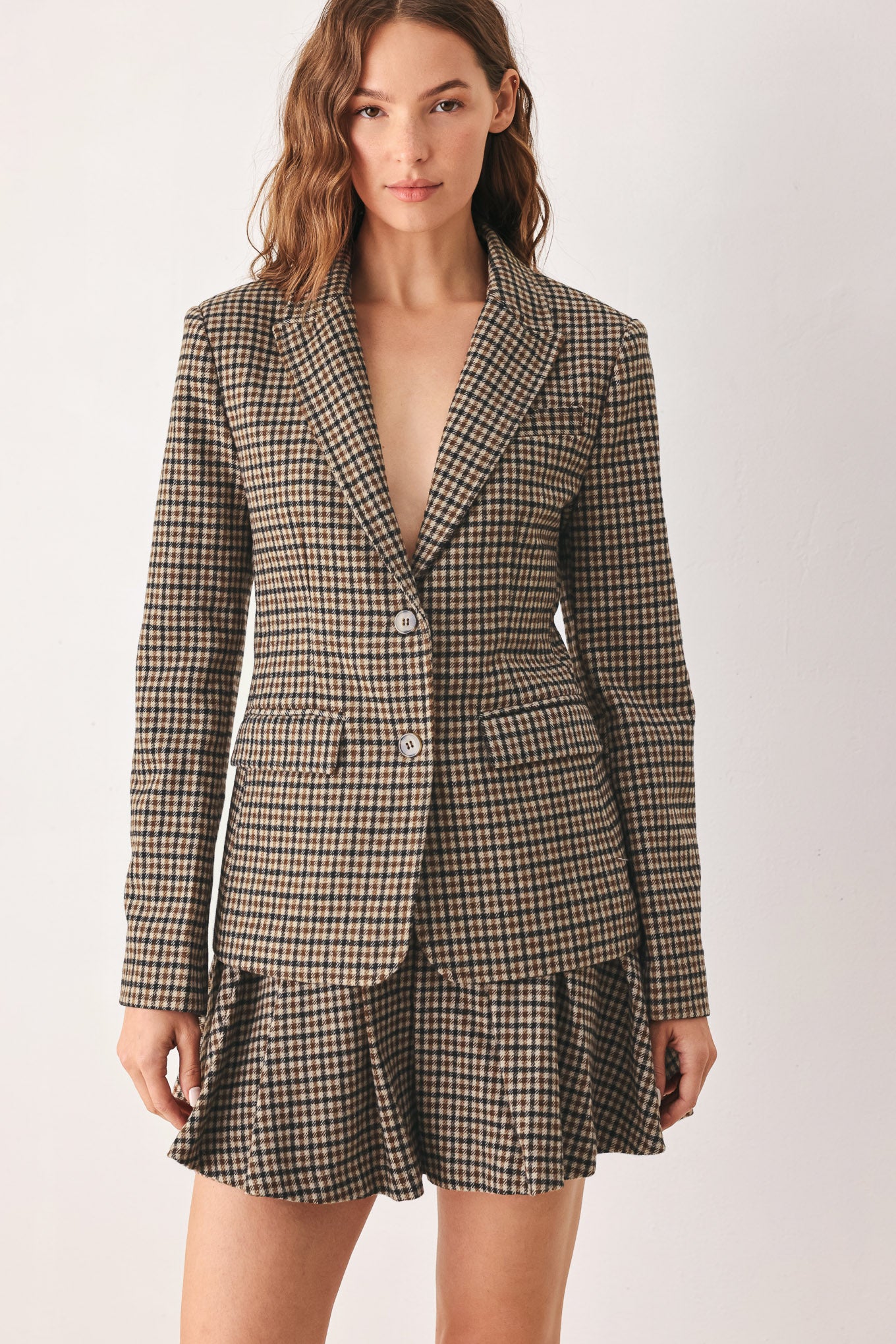 A woman modeling a matching two-piece blazer in a brown and beige houndstooth pattern | FREEMARKET