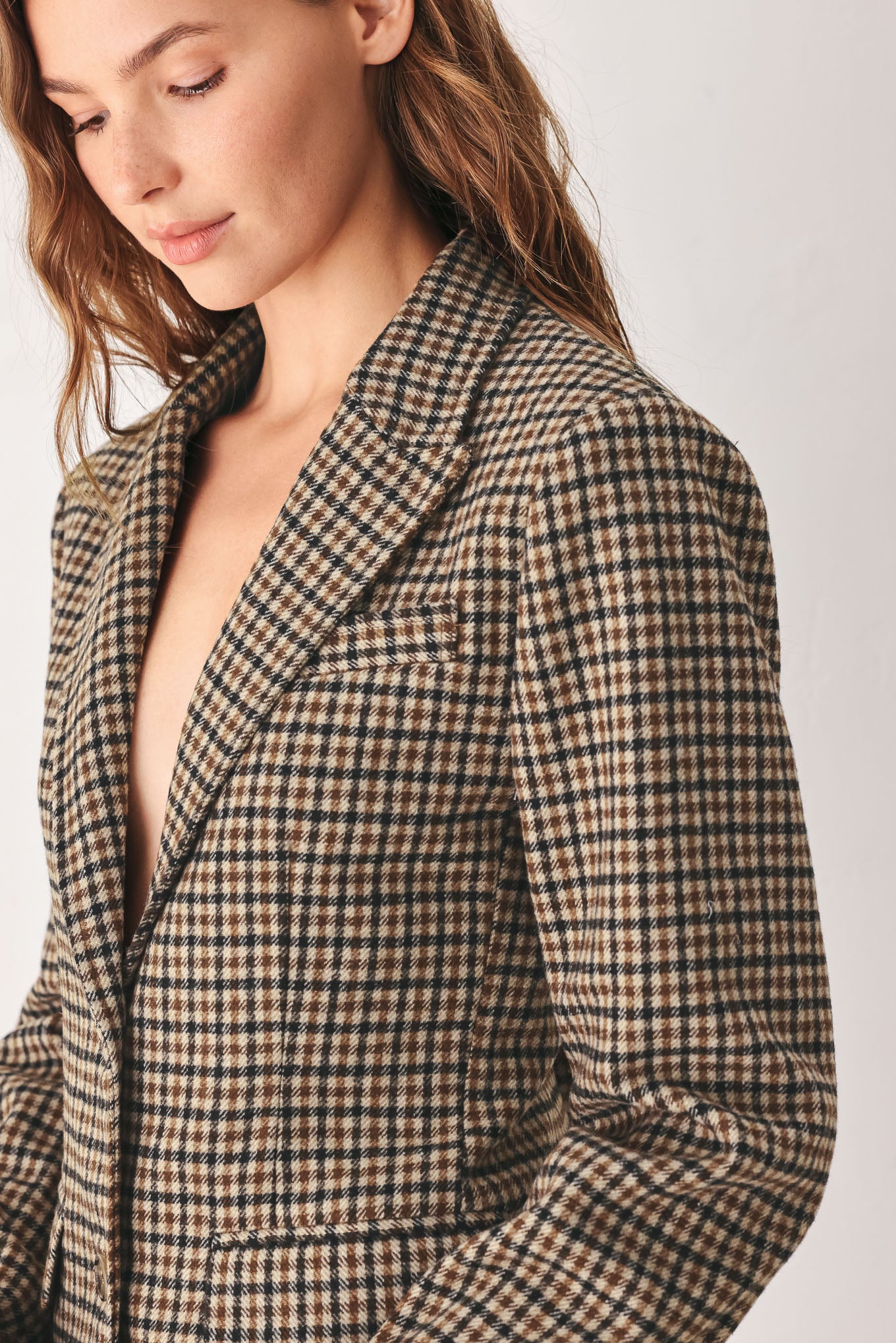 A woman modeling a matching two-piece blazer in a brown and beige houndstooth pattern | FREEMARKET