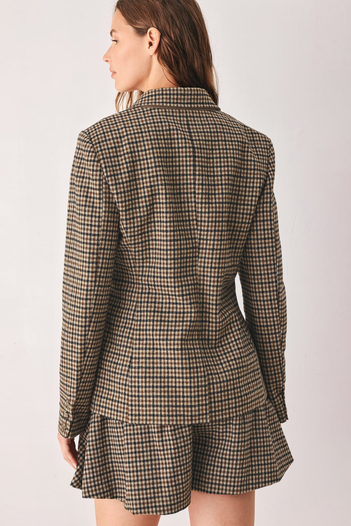 A woman modeling a matching two-piece blazer in a brown and beige houndstooth pattern | FREEMARKET