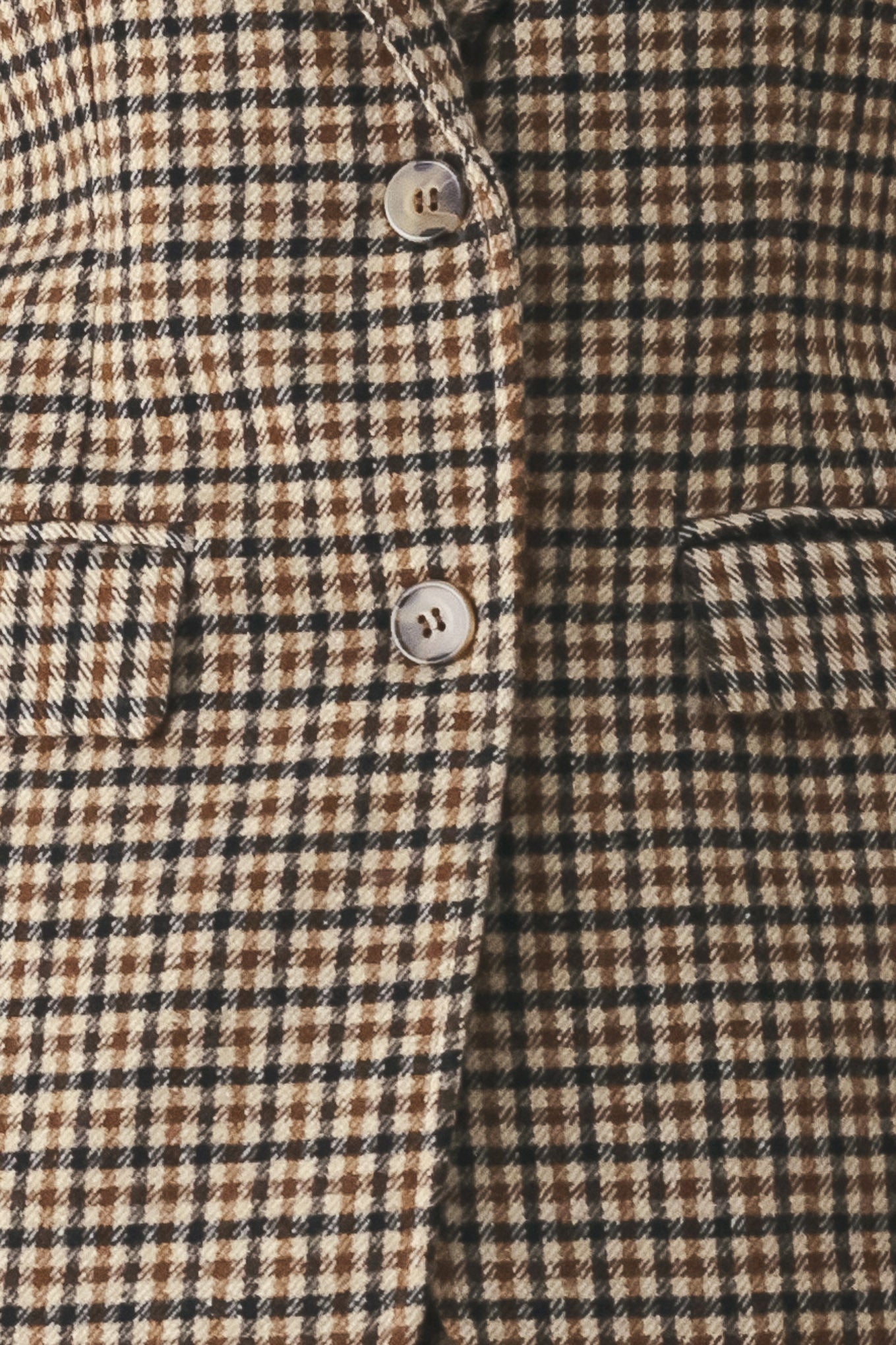 A woman modeling a matching two-piece blazer in a brown and beige houndstooth pattern | FREEMARKET