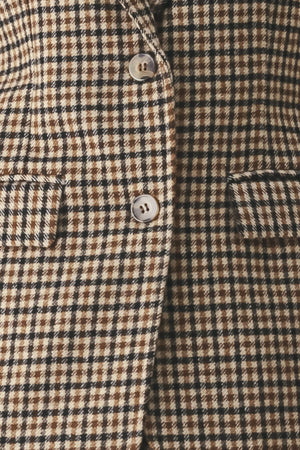 A woman modeling a matching two-piece blazer in a brown and beige houndstooth pattern | FREEMARKET