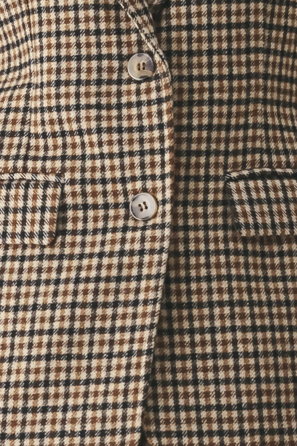 A woman modeling a matching two-piece blazer in a brown and beige houndstooth pattern | FREEMARKET
