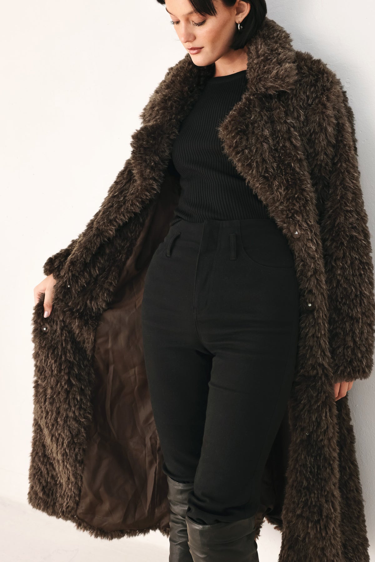 A woman modeling a long, dark brown shaggy faux-fur coat | FREEMARKET