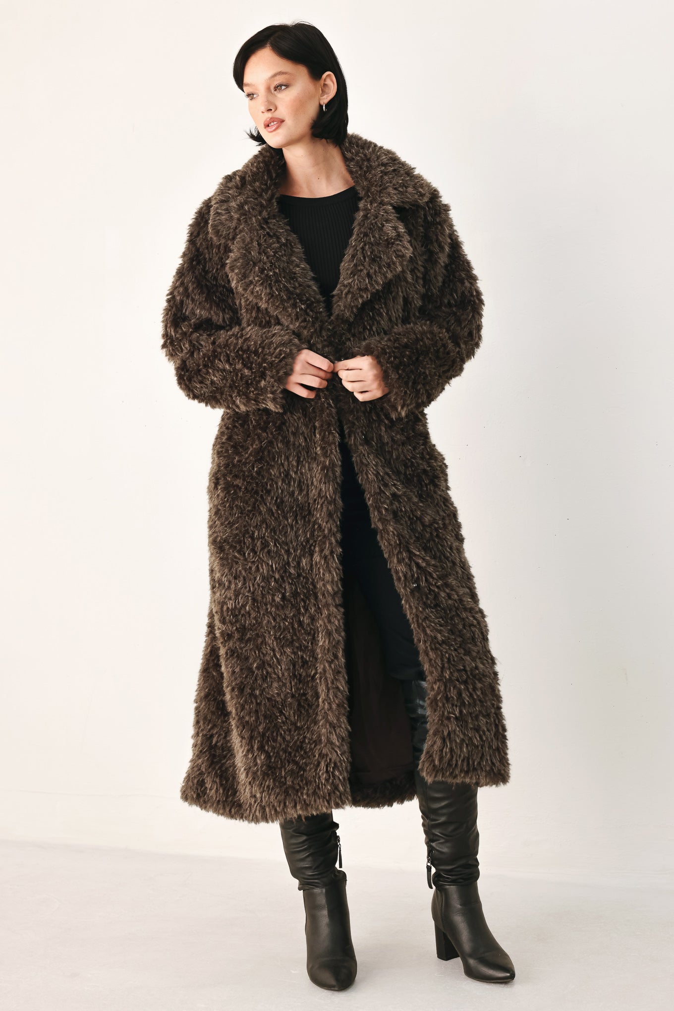 A woman modeling a long, dark brown shaggy faux-fur coat | FREEMARKET
