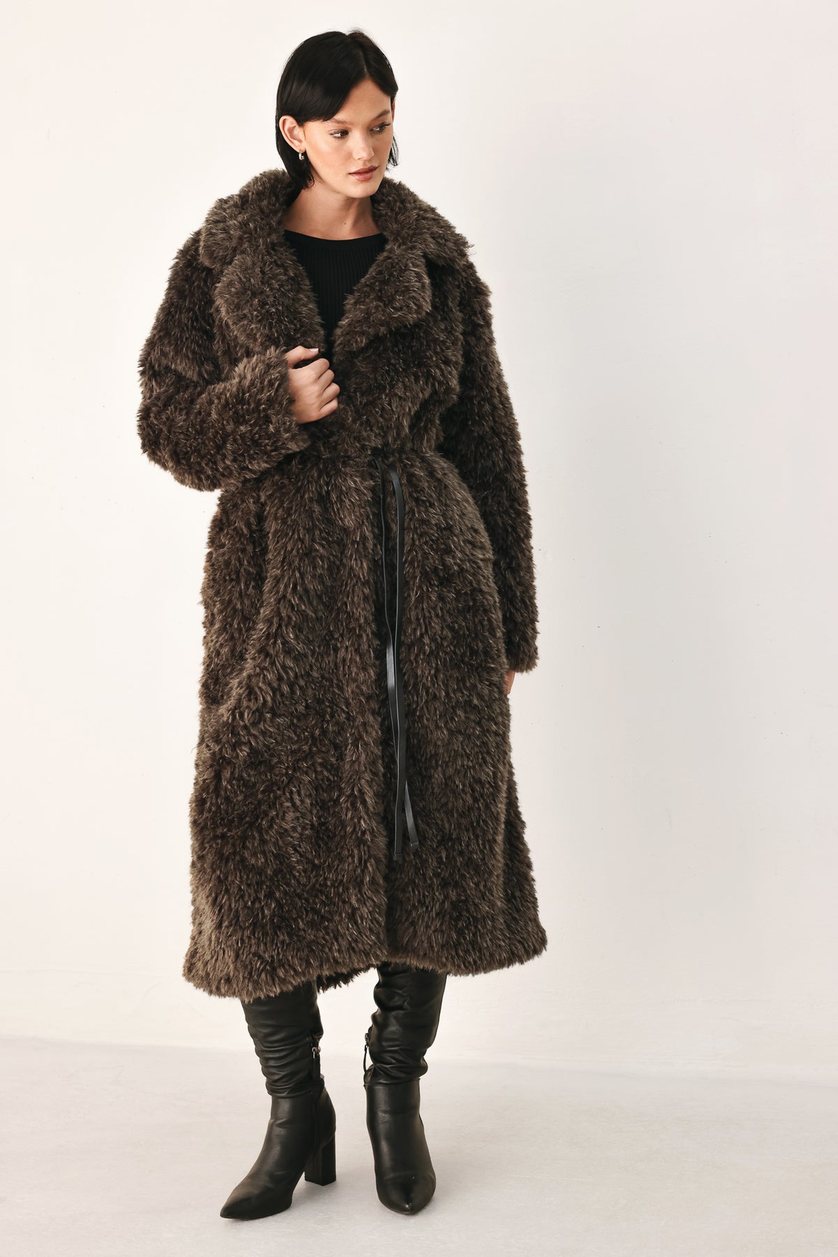 A woman modeling a long, dark brown shaggy faux-fur coat | FREEMARKET