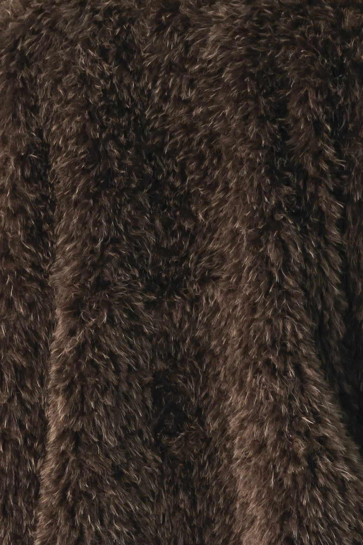 A woman modeling a long, dark brown shaggy faux-fur coat | FREEMARKET