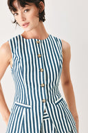 Woman wearing a blue and white striped sleeveless vest with buttons | FREEMARKET