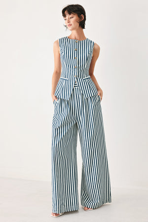 Woman wearing a blue and white striped sleeveless vest with buttons | FREEMARKET