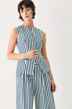 Woman wearing a blue and white striped sleeveless vest with buttons | FREEMARKET