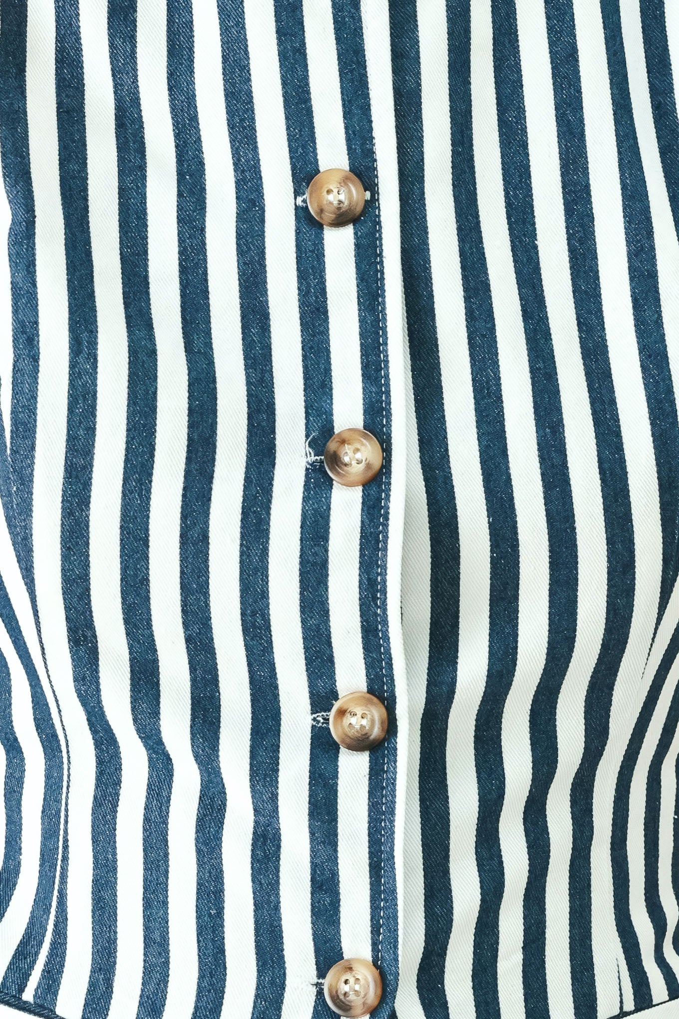 Woman wearing a blue and white striped sleeveless vest with buttons | FREEMARKET