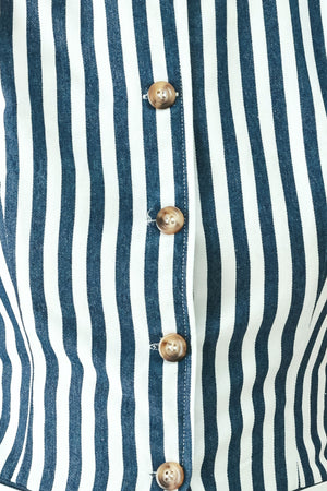 Woman wearing a blue and white striped sleeveless vest with buttons | FREEMARKET