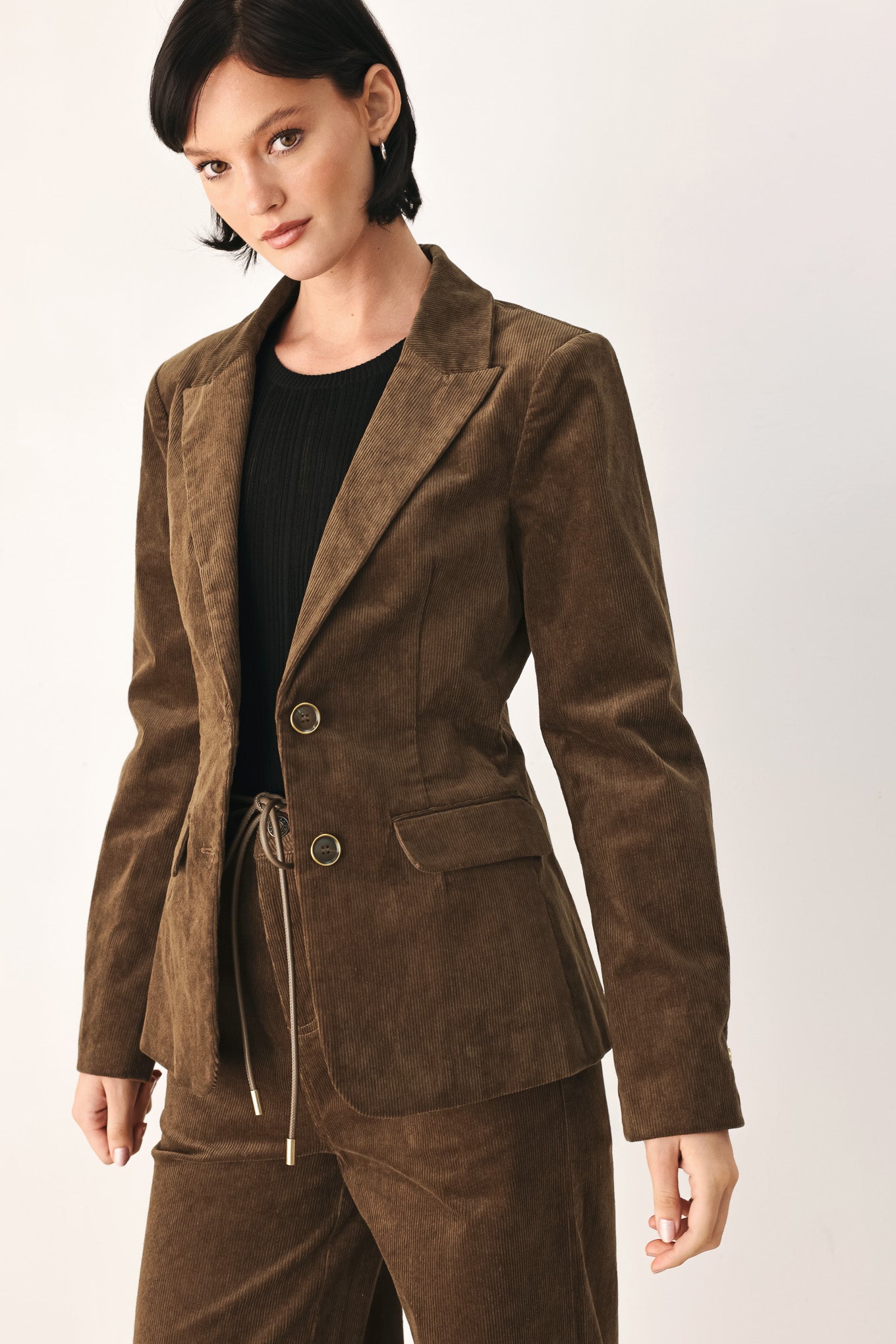 A woman wearing a brown corduroy blazer | FREEMARKET
