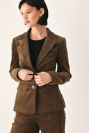 A woman wearing a brown corduroy blazer | FREEMARKET