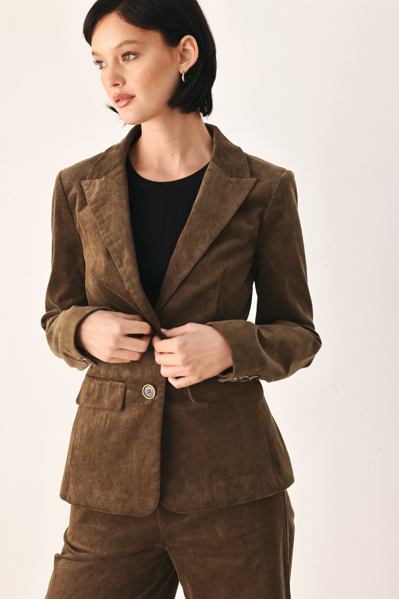 A woman wearing a brown corduroy blazer | FREEMARKET