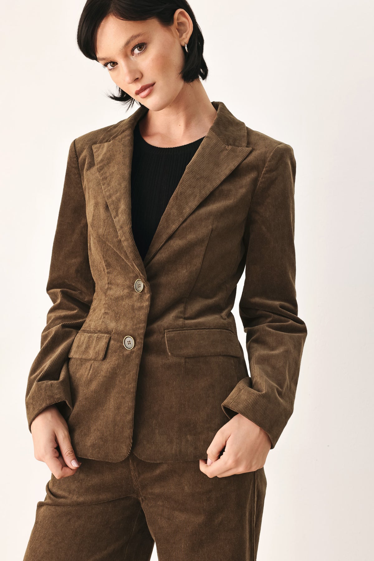 A woman wearing a brown corduroy blazer | FREEMARKET
