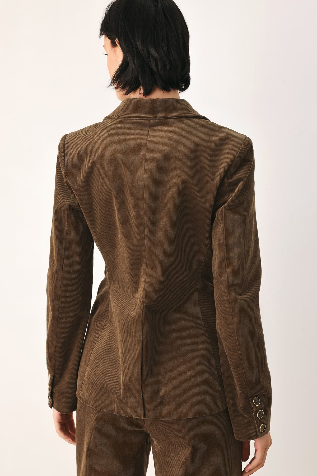 A woman wearing a brown corduroy blazer | FREEMARKET