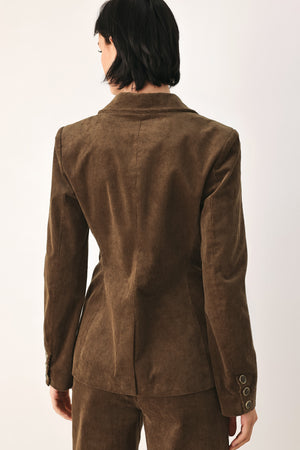 A woman wearing a brown corduroy blazer | FREEMARKET