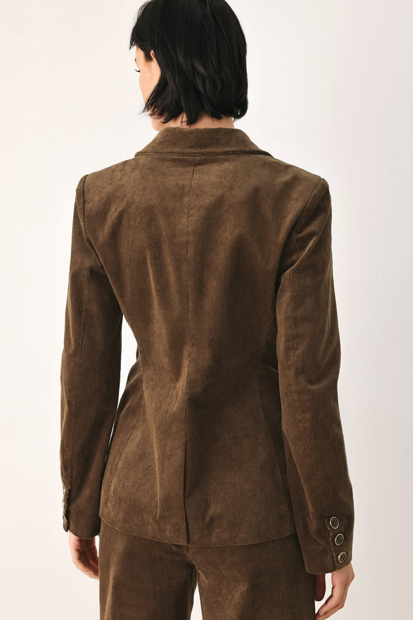 A woman wearing a brown corduroy blazer | FREEMARKET