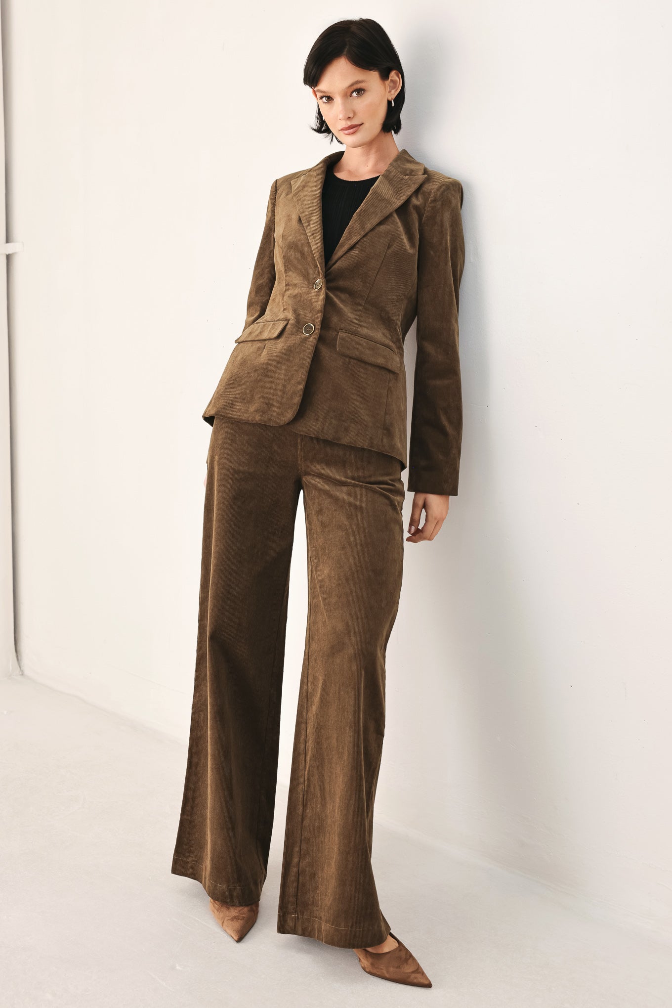 A woman wearing a brown corduroy blazer | FREEMARKET