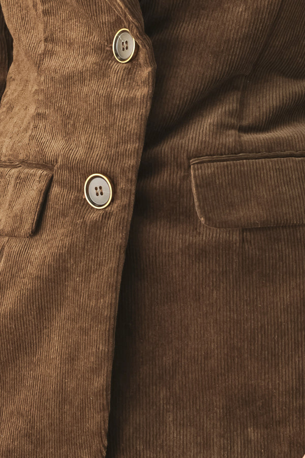 A woman wearing a brown corduroy blazer | FREEMARKET